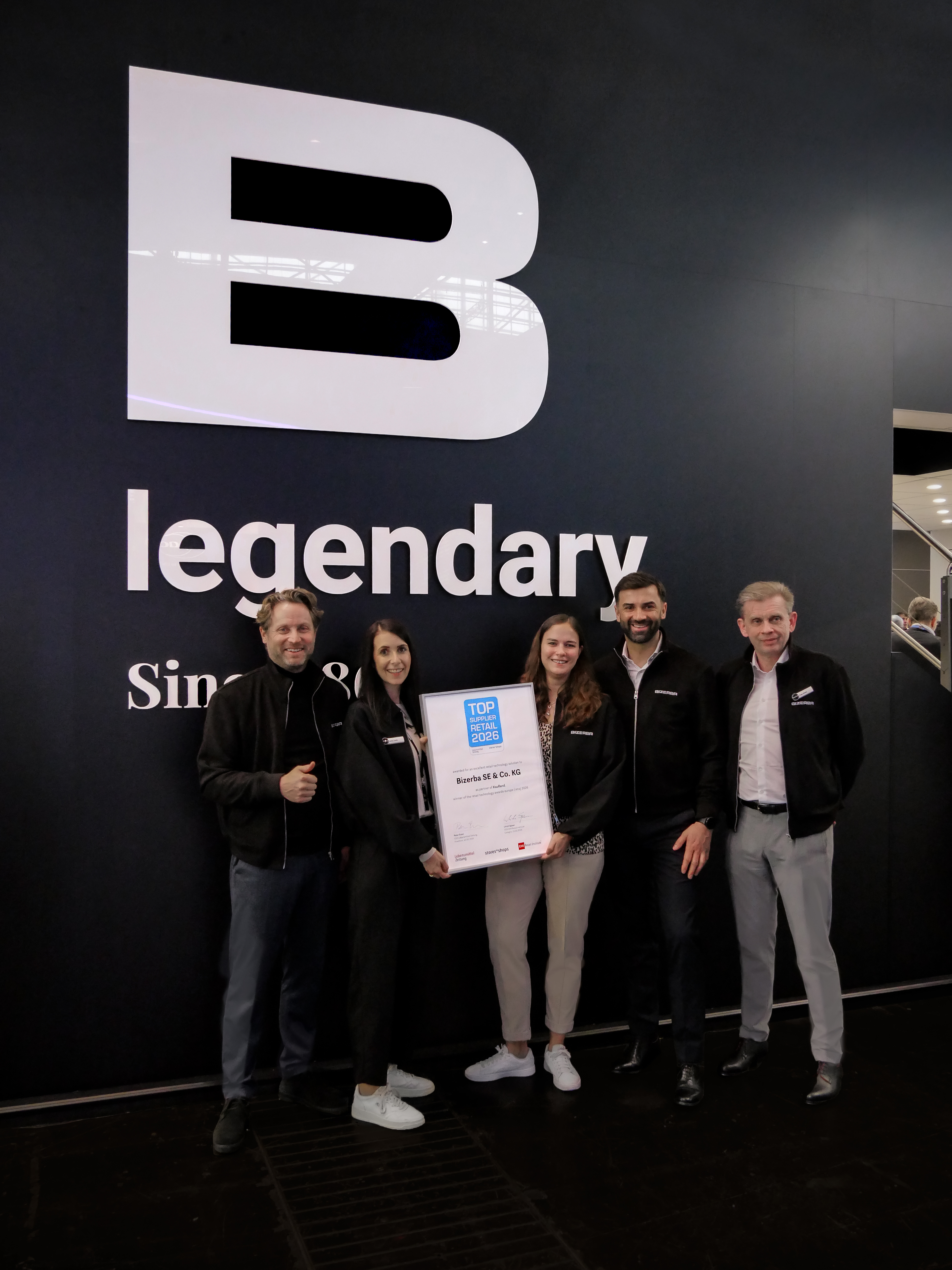 The BIZERBA team proudly presents its recognition as “Top Supplier Retail 2026” at the company’s booth at Euro-Shop in Düsseldorf. © Bizerba